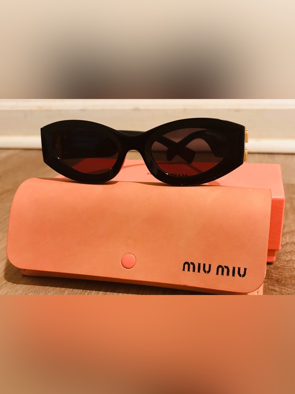 Miu Miu Black Oval Sunglasses with Orange Case